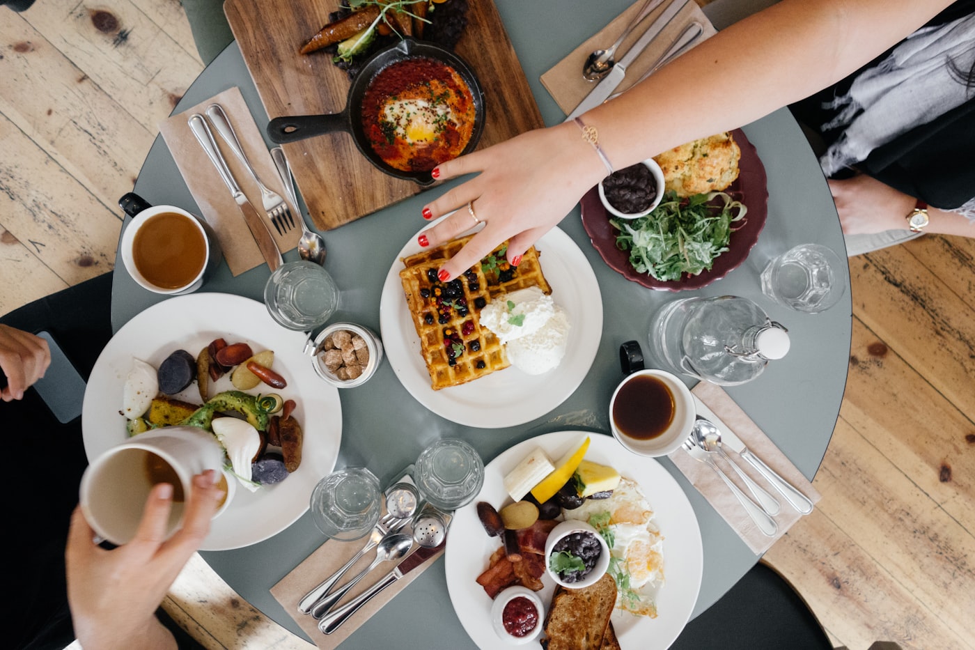 Hands over a shared table, seen from above